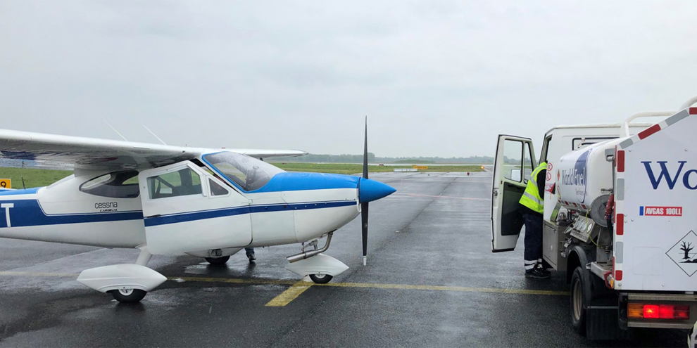 Light aircraft by fuel tank.